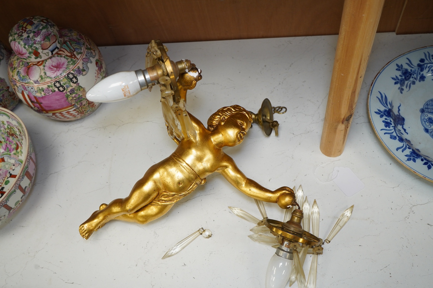 A gilt plaster hanging ‘cherub’ light fitting, 33cm long. Condition - fair